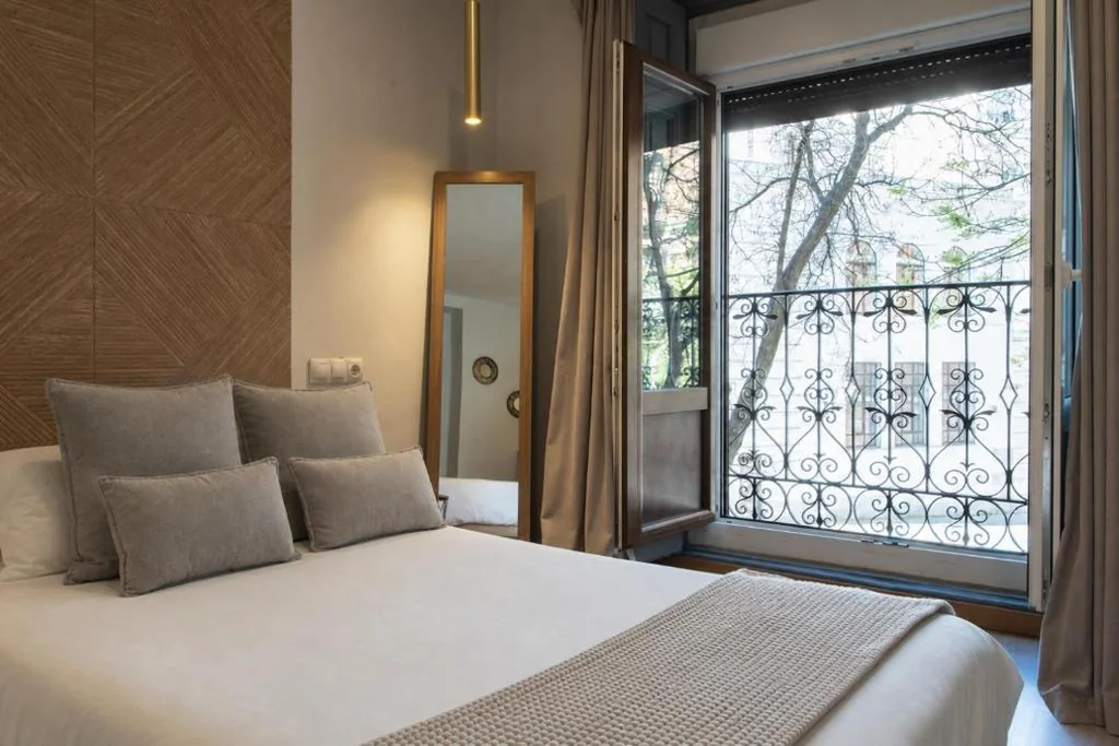 Room with Large Bed and Balcony — AbraCadabra Suites