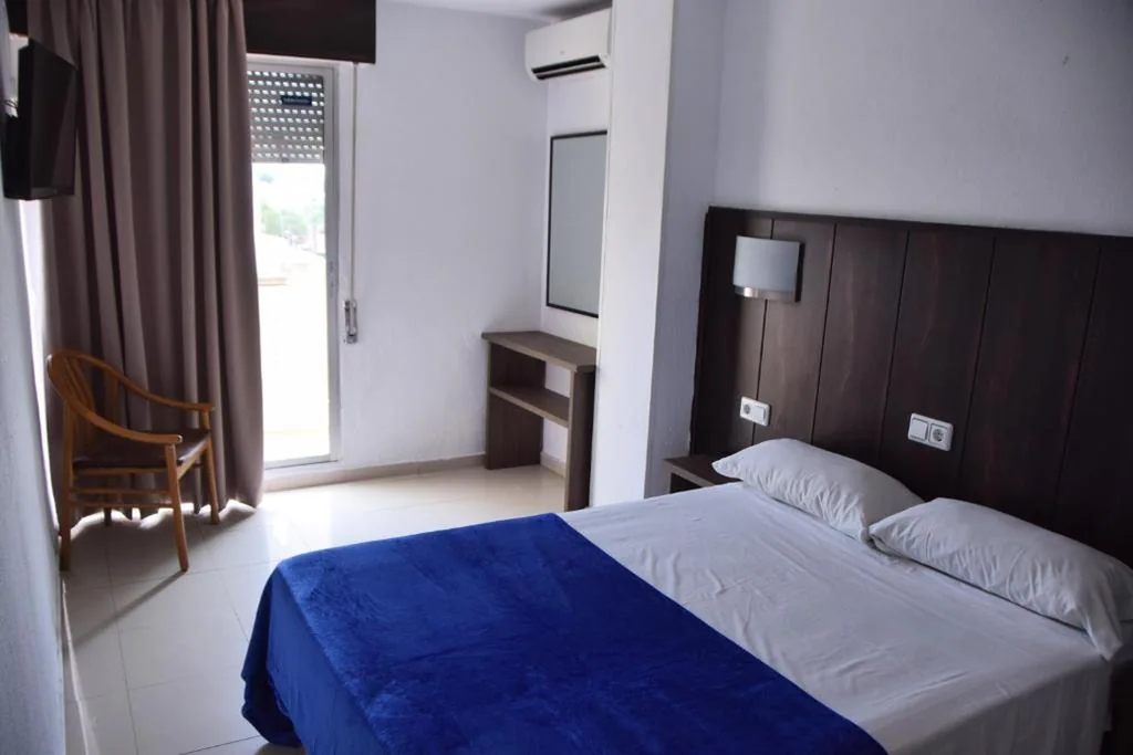 Habitación con cama grande y balcón — Hotel Niza