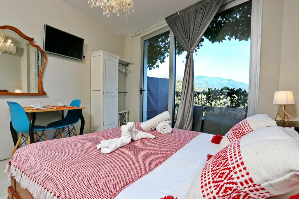 Habitación con cama extragrande y balcón — Les Suites