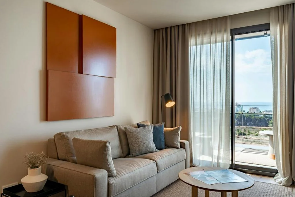 One-Bedroom Deluxe Queen Suite with Partial Sea View — Sabàtic Sitges Hotel, Autograph Collection